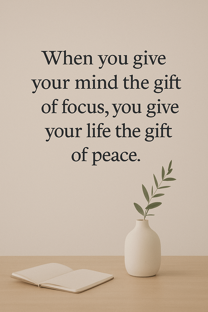 alming minimalist setup featuring a blank notebook and a white vase with a leafy branch on a light wooden surface, set against a beige background. An inspirational quote above reads, “When you give your mind the gift of focus, you give your life the gift of peace,” visually reinforcing the benefits of monotasking for mental clarity and emotional well-being.